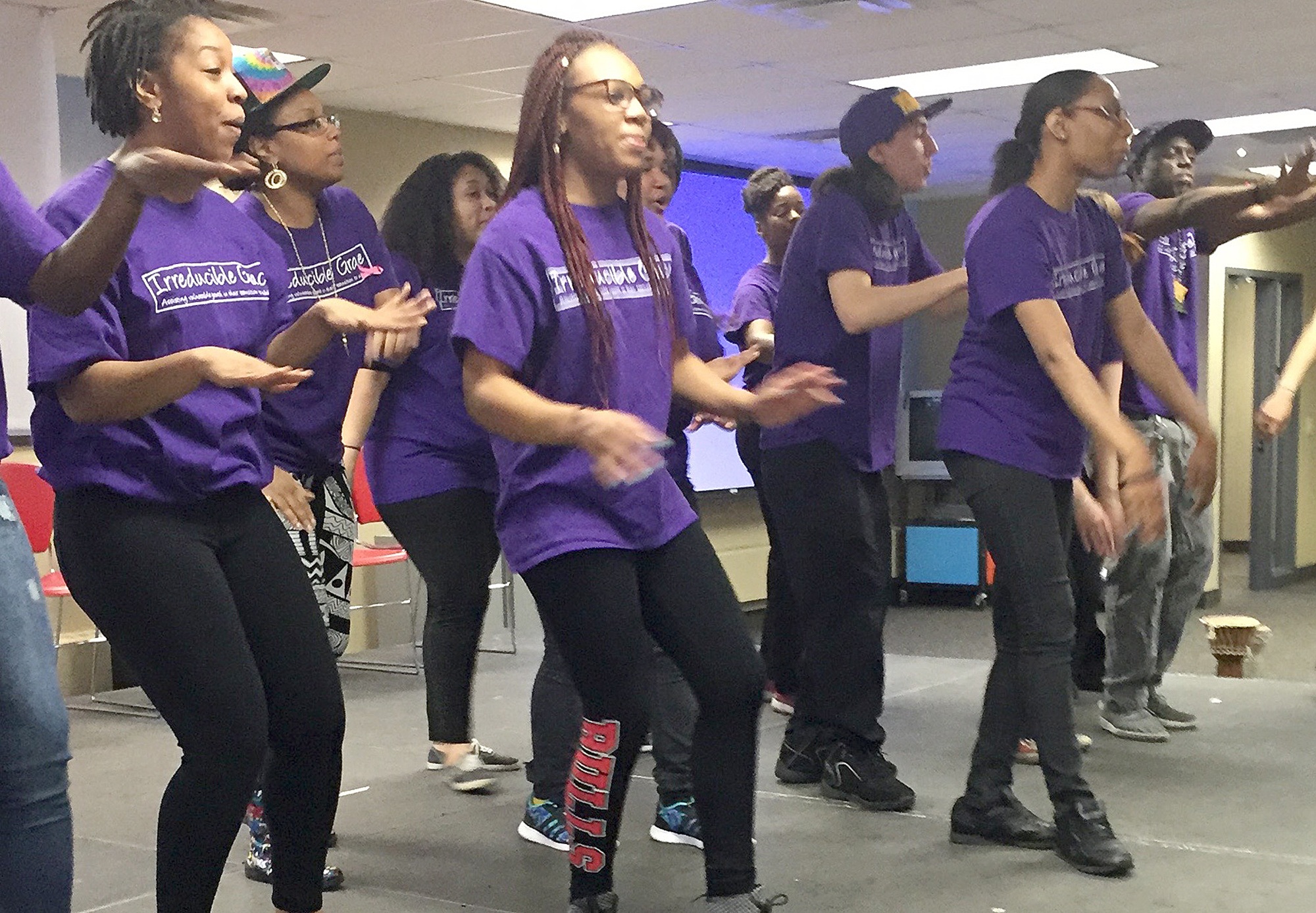 Young people in the Irreducible Grace Foundation perform at a community event. 